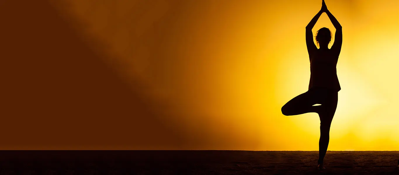 Girl is performing Yoga asana in morning golden light
