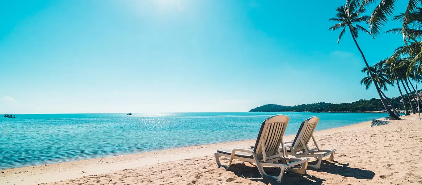 Deck chairs on the sand overlooking the beach